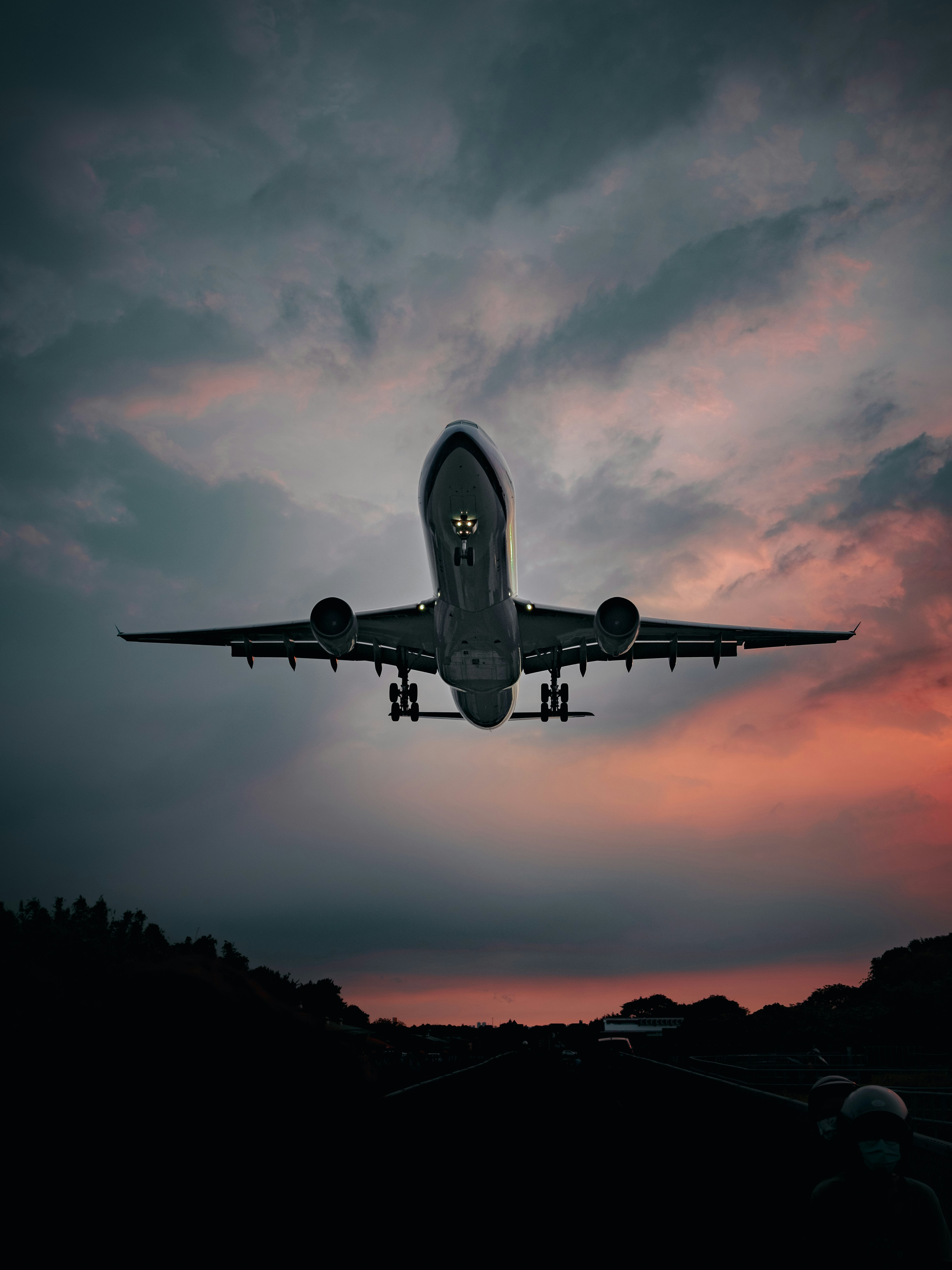 airplane flying in the sky during sunset